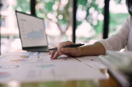 Woman with computer and paper