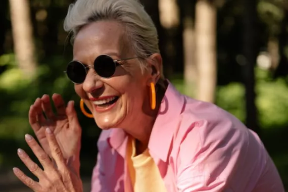 Older woman with sunglasses in sunshine