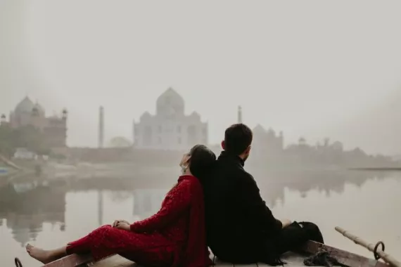 A couple sitting by the river